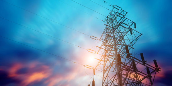 Energy Pylon from below, looking up, against a blue and pink sky