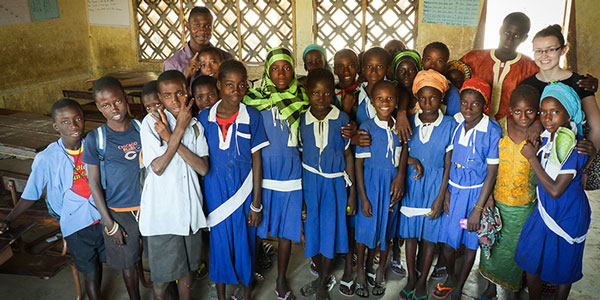 Electronic and Electrical Engineering students pose for a photograph with school pupils in a school in Gambia