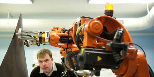 a researcher looking at a large orange drill