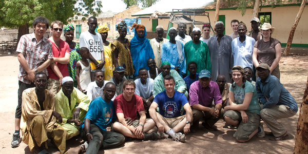 Electronic & Electrical Engineering students posing for a group shot with a community in Gambia