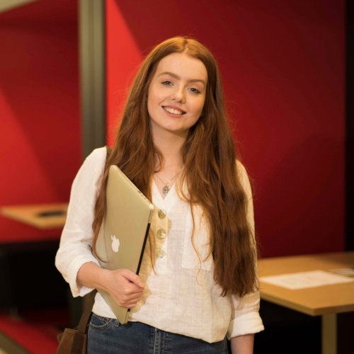 Student holding laptop