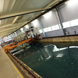 a technician stands on the platform of suspended over the kelvin hydrodynamics lab water tank