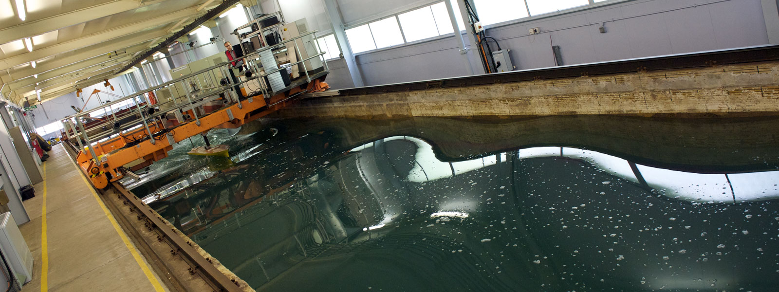 a technician stands on the platform suspended above the kelvin hydrodynamics laboratory tank