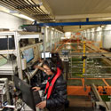 two students analyse data on a computer on a platform over a water tank