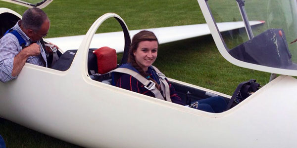 Gemma Houston in a Glider, smiling at the camera