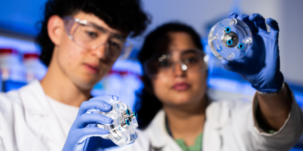 Lab students holding out components Lab students holding out components