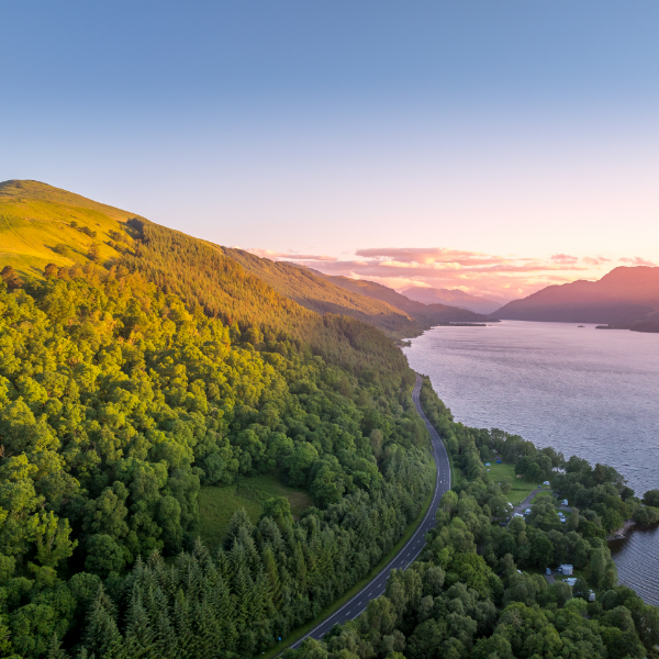 Aerial image of green hilly Scottish landscape near water