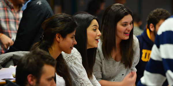 three female entrepreneurs looking excitedly off camera and smiling