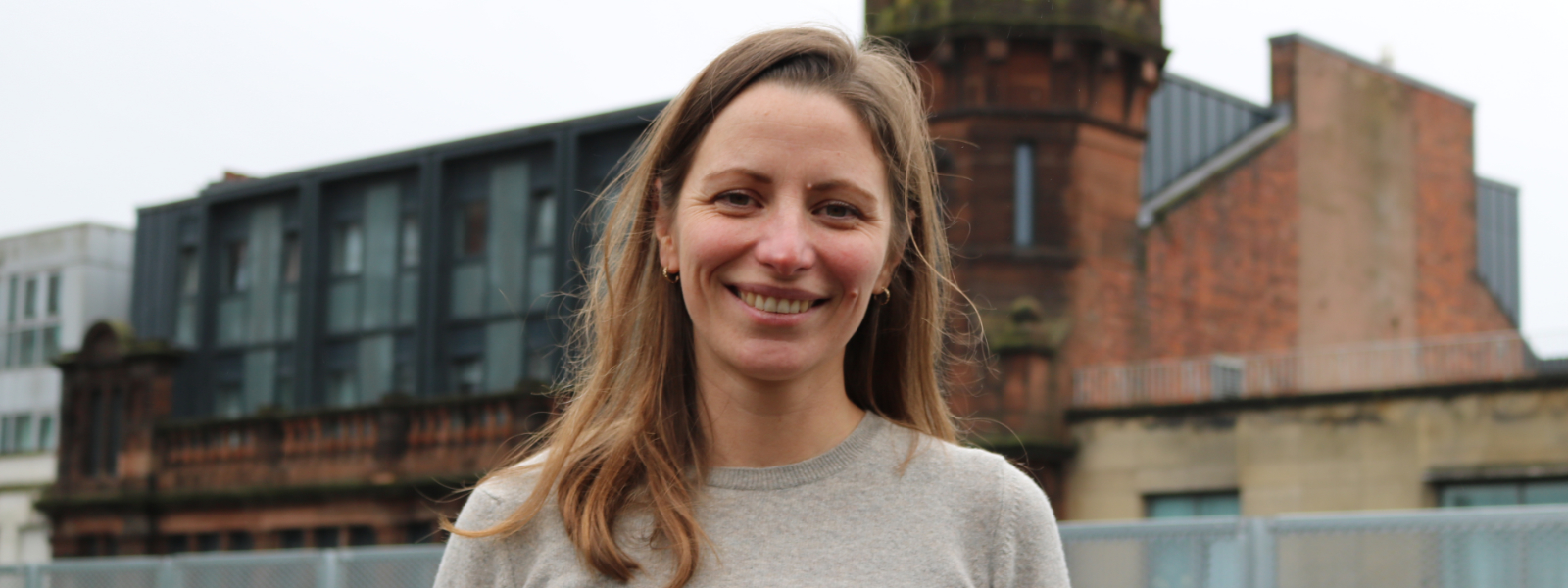 Stefanie Reher, a Reader in Politics at Strathclyde, stands outside a University building