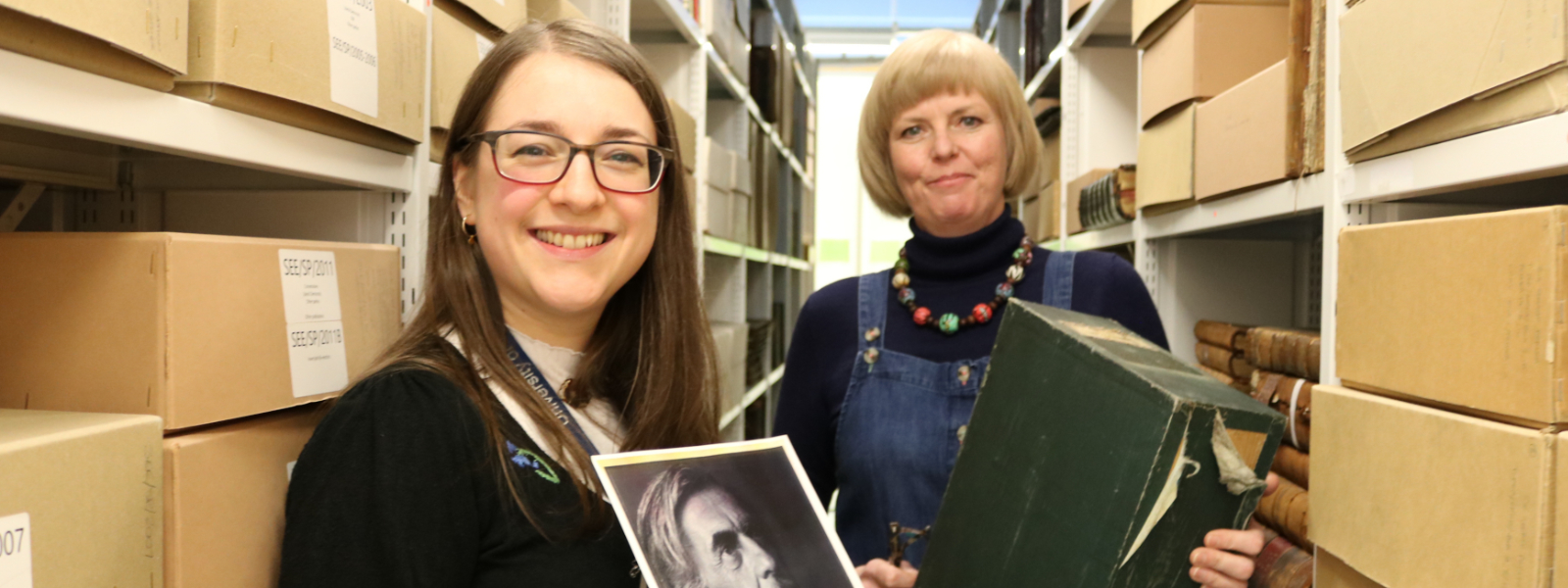 Rachael Jones, Assistant Archivist at the University of Strathclyde Library's Archives & Special Collections, and Dr Eleanor Bell, Senior Lecturer in English at the University of Strathclyde stand side by side holding the box which contained the long-lost manuscript recently discovered