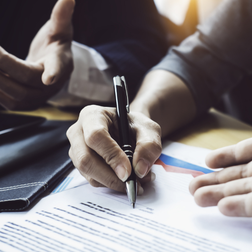 A hand signing a legal document