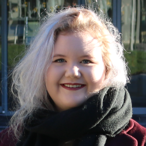 A smiling female wearing a scarf