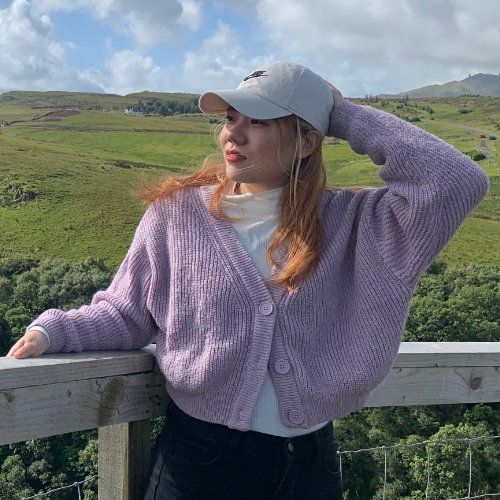 A young woman in a white hat standing in a field