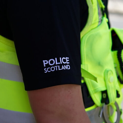Police officer on duty on a city centre street during special event Police officer on duty on a city centre street during special event