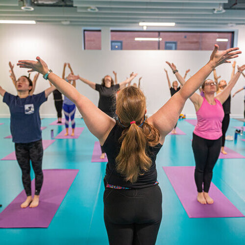 Personal trainer teaching a yoga class at Strathclyde Sport