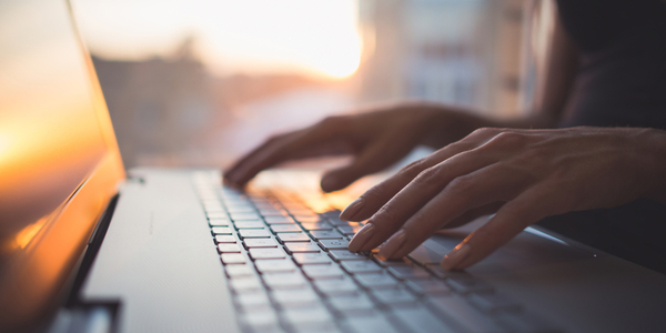 hands typing on keyboard