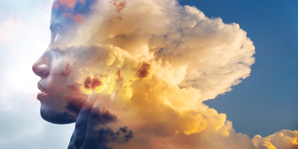 An image of a woman's face in clouds