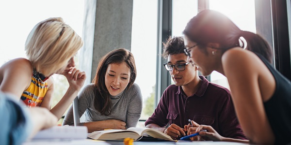 students gathered round a table