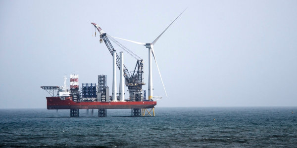 A wind turbine on a rig in the ocean
