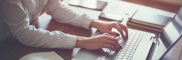 hands typing on keyboard