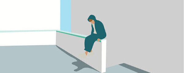 Young man in green hoody coat who lost job abandoned and lost in depression sitting on white wall, looking away suffering emotional pain, crying alone.