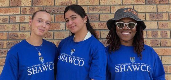 three students smiling in SHAWCO tshirts