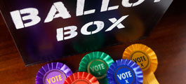 a ballot box with colourful ribbons saying 'vote'