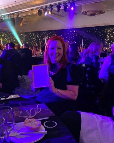 Pauline McKay holding award certificate at Legal Awards ceremony