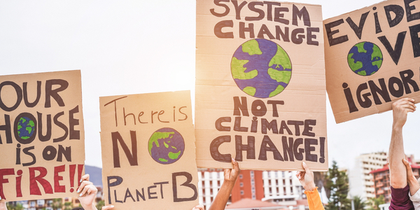 Group of demonstrators on road, young people from different culture and race fight for climate change - Global warming and enviroment concept - Focus on banners