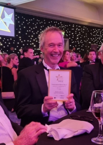 Photograph of Charlie Irvine holding award certificate at Legal Awards ceremony