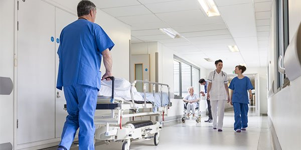 People walking along a corridor in a hospital