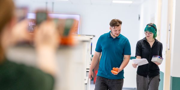 Students walking and talking in lab