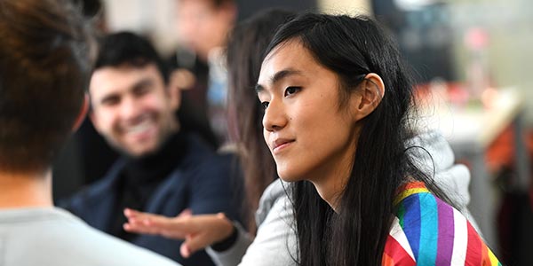 Students in study area talking.