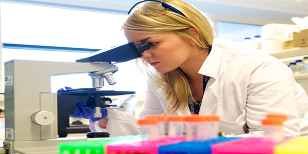 Researcher with microscope