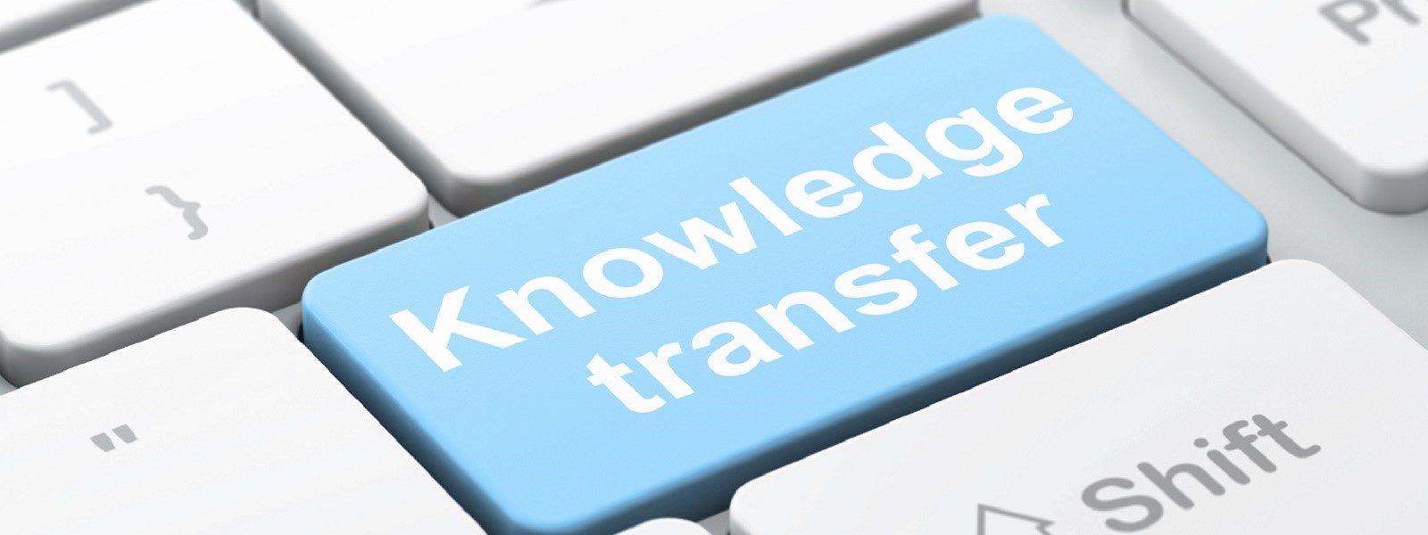 Computer button displaying words 'knowledge transfer'