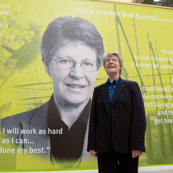 Dame Jocelyn Bell Burnell in front of a large-scale mural in the Learning Village Dame Jocelyn Bell Burnell in front of a large-scale mural in the Learning Village