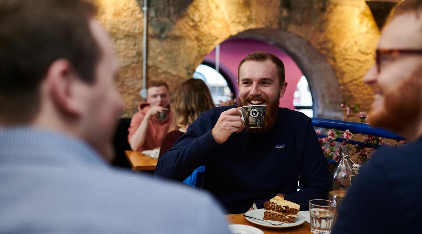 Scott Kennedy from Revive Eco drinking coffee in a cafe.