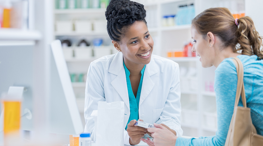 Pharmacist speaking to a customer about antibiotics  