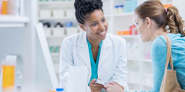 Pharmacist speaking to a customer