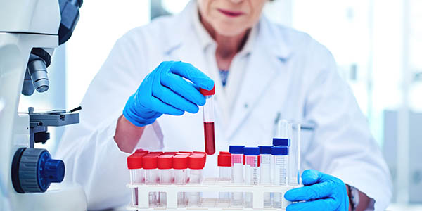 Scientist looking at a test tube.