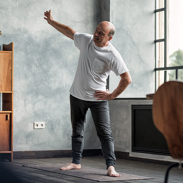 Man stretching at home 