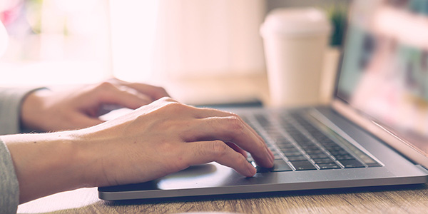 Person typing on a laptop Person typing on a laptop