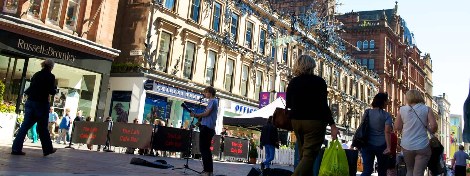 Shoppers on Buchanan Street with buskers entertaining