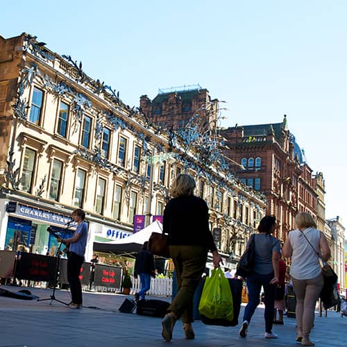 Buchanan Street shoppers with buskers entertaining