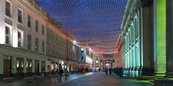 Royal Exchange Square at night, lit up in lights