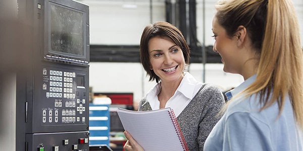 Factory executive talking to a female apprentice employee