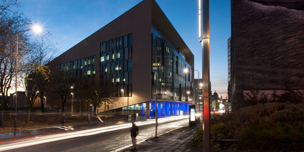 a long exposure shot of the technology and innovation centre at dusk, with lights streaming through george street