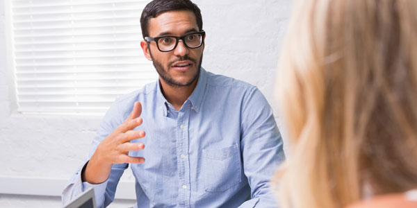 a man chats to a potential employer in a job interview