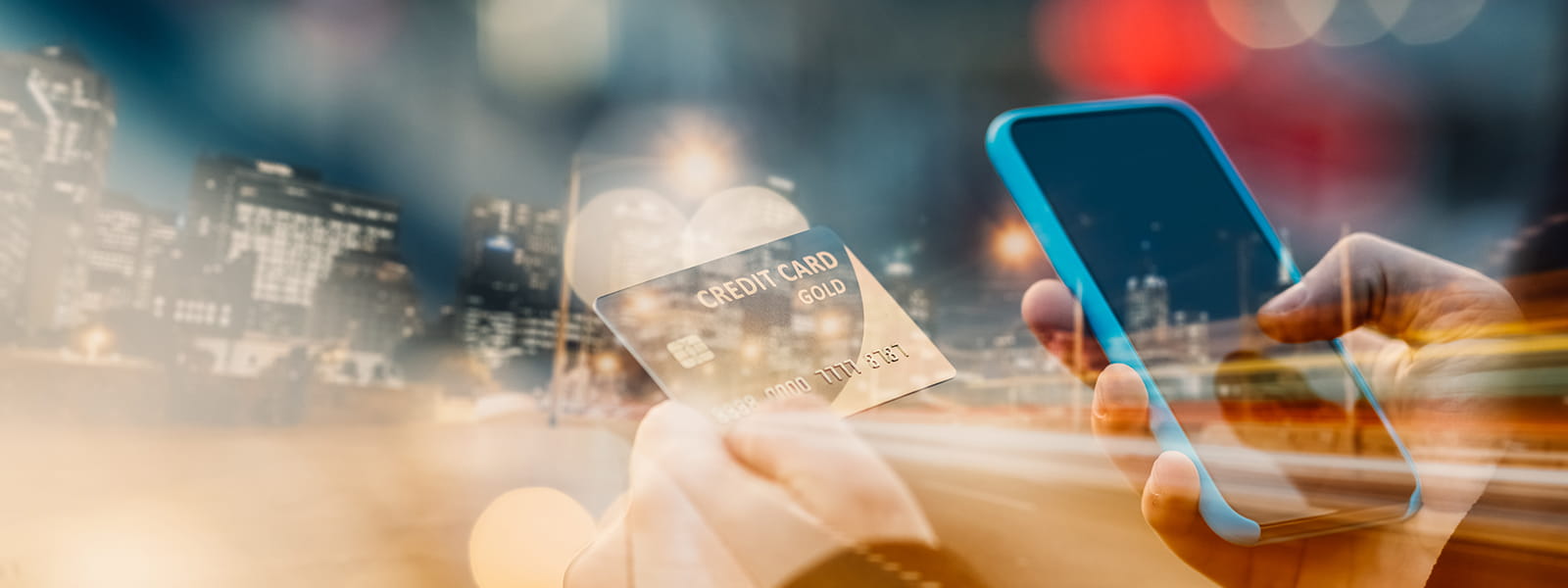 A person holding a mobile phone and credit card