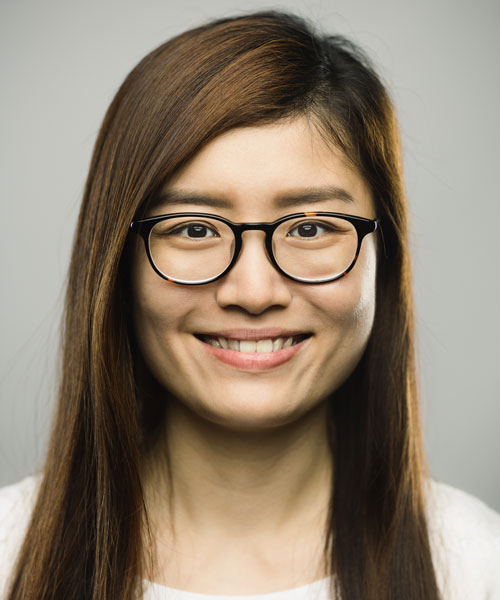 portrait of asian young woman with happy expression against gray white background.